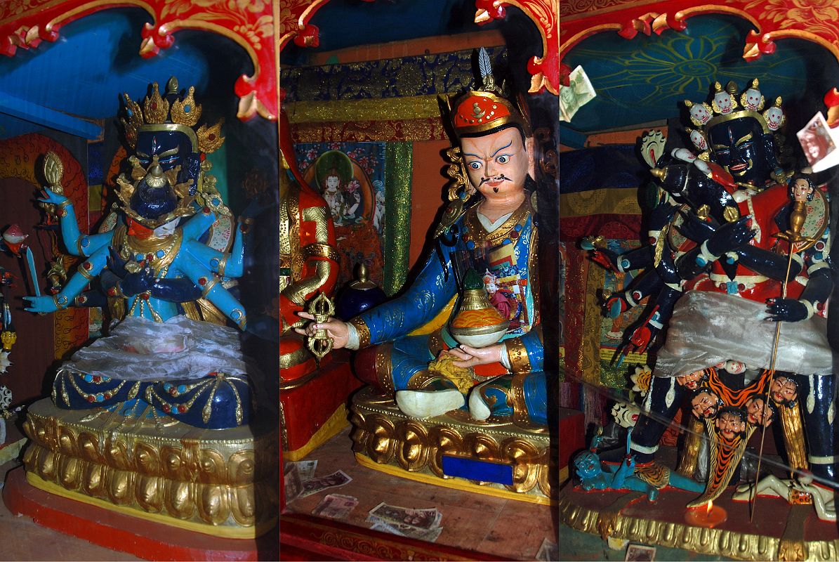 26 Trugo Gompa Statues Of Guhyasamaja Akshobhyavajra, Padmasambhava And Chakrasamvara Trugo Gompa has statues of Guhyasamaja Akshobhyavajra, Padmasambhava (Tib. Guru Rinpoche), and Chakrasamvara. The left statue is dark blue Guhyasamaja Akshobhyavajra in yab yum with his consort who is light blue. Gurla Mandhata in Western Tibet is considered to be his paradise. Guhyasamaja is dark blue in colour as distinct from the light blue complexion of his consort, with two hands crossed against the breast holding a vajra and ghanta bell, his upper right and left hands holding a chakra wheel and flaming jewel, and his two lower hands holding a lotus and sword. His consort has three faces: red, light blue, and white. Her original hands embrace the yab at the back, the upper hands hold the flaming mani jewel and chakra wheel while the lower ones carry the sword of wisdom and lotus. The dark blue right statue on the right is Chakrasamvara with his red consort Vajravarahi (Tib.: Dorje Pagmo). His two central hands embrace his consort and hold a vajra and bell. His right hands hold a damaru drum, an axe, a curved chopper and a trident. One of his left hands holds a khatvanga.
